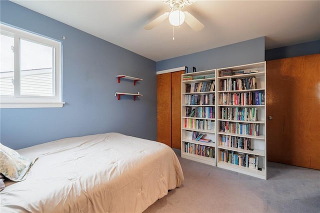 carpeted bedroom with a ceiling fan