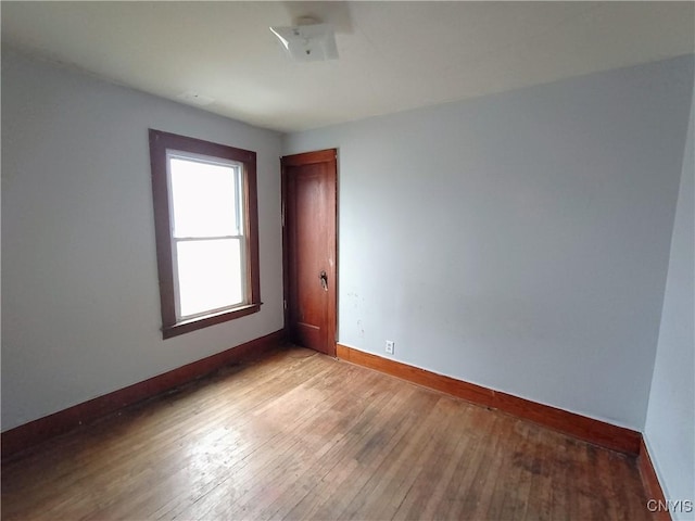 spare room featuring light wood-style flooring and baseboards