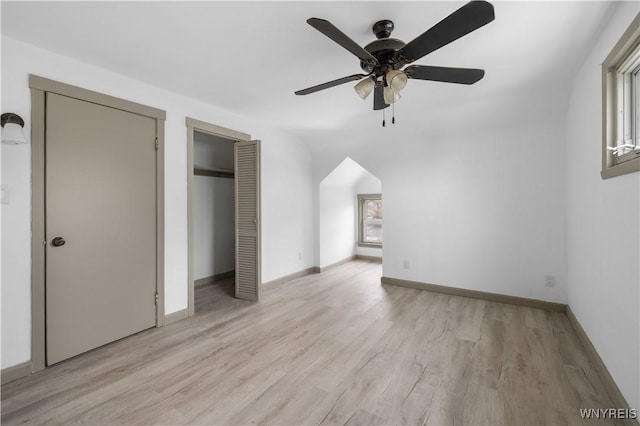 unfurnished bedroom featuring light wood-type flooring, ceiling fan, and baseboards