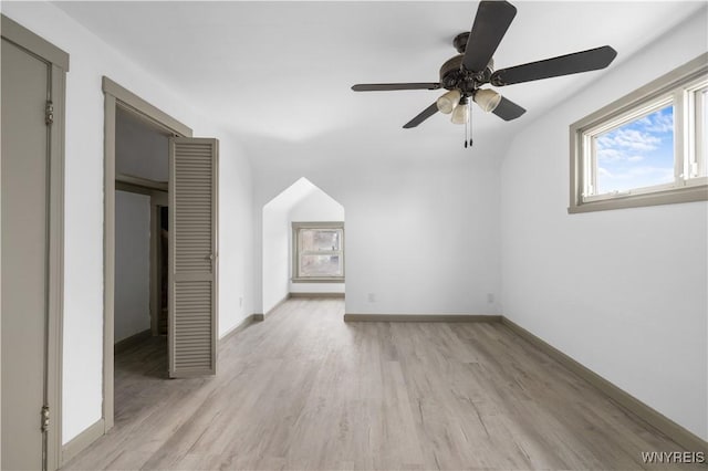 bonus room with light wood-type flooring, baseboards, and a ceiling fan