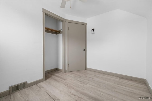 unfurnished bedroom with a closet, visible vents, light wood-style flooring, and baseboards