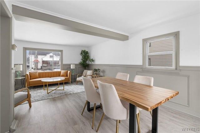 dining area with wainscoting and wood finished floors