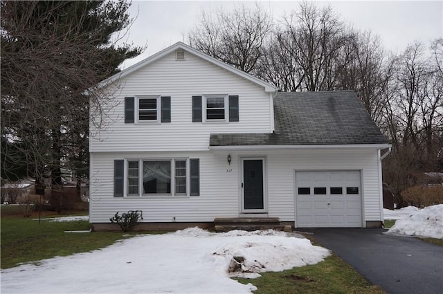 view of front of property with a garage, aphalt driveway, and roof with shingles