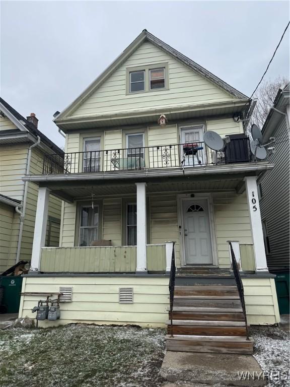 view of front facade featuring a balcony and a porch