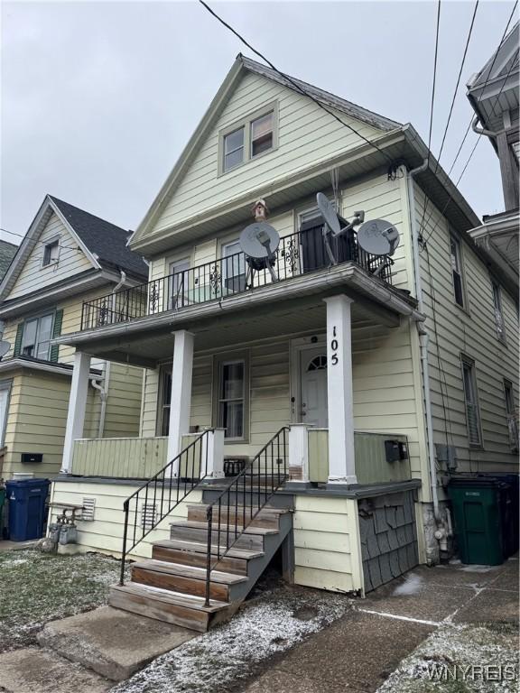 view of front of house featuring covered porch and a balcony