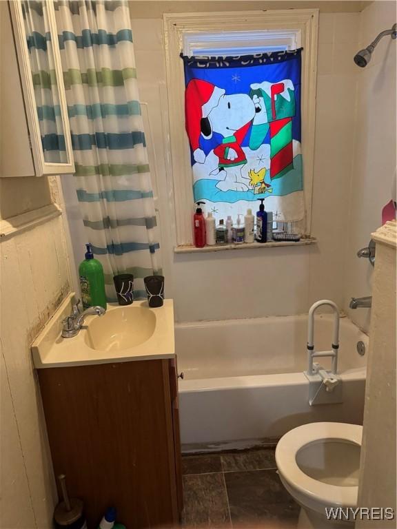 full bathroom with toilet, shower / tub combo, and vanity