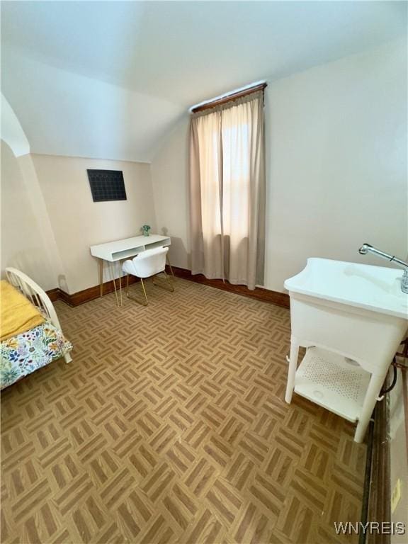 bedroom with vaulted ceiling and baseboards