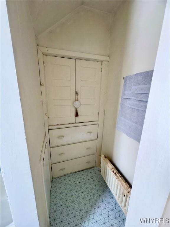 interior space with radiator and vaulted ceiling