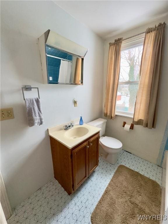 bathroom with toilet, tile patterned floors, a shower with shower curtain, and vanity