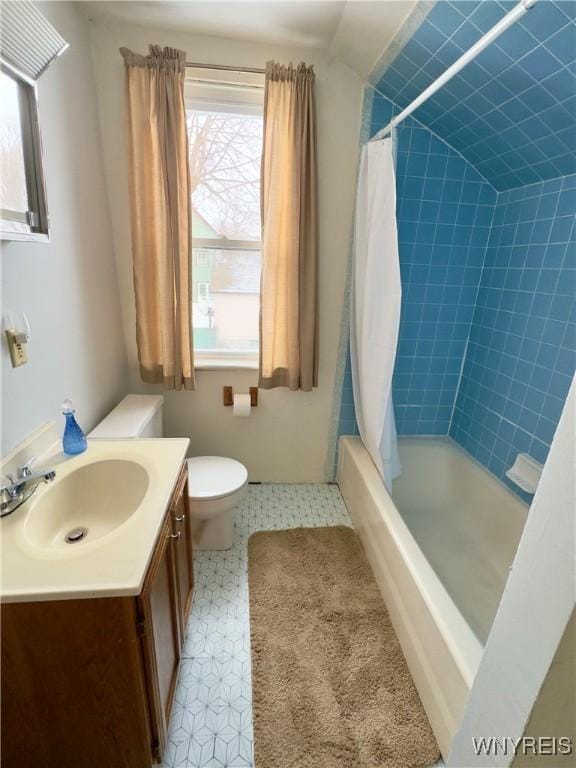 full bath with toilet, tile patterned floors, vanity, and shower / bathtub combination with curtain