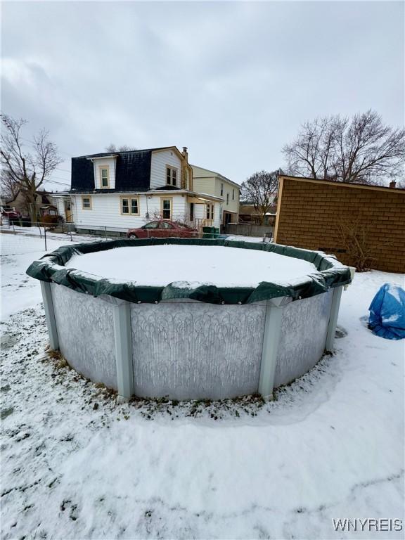 snow covered pool featuring a covered pool