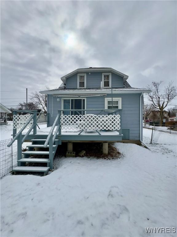 view of front of house featuring stairs, fence, and a wooden deck