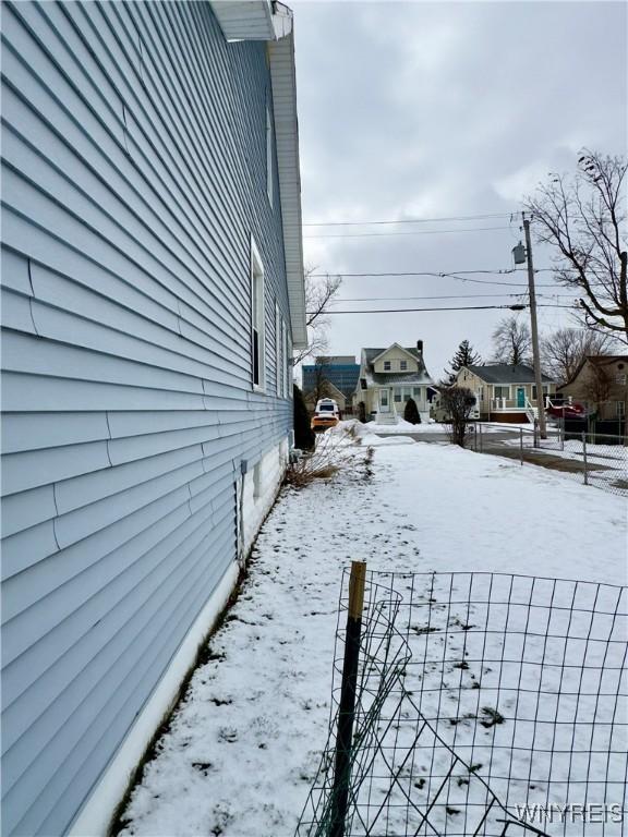 yard covered in snow with fence