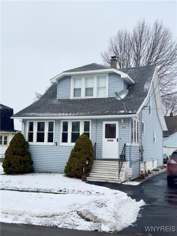 bungalow featuring entry steps and a chimney