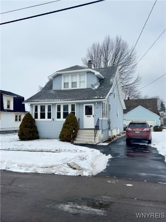 view of front of home featuring a detached garage and an outbuilding