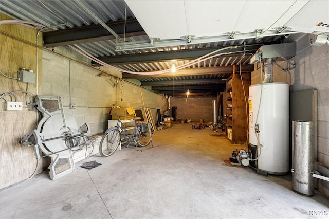 basement featuring concrete block wall and water heater