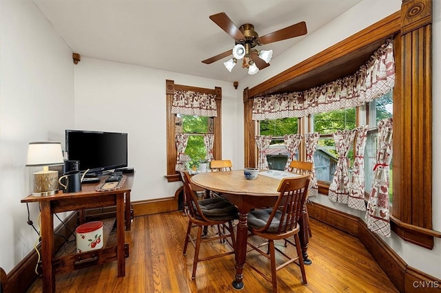 dining space featuring ceiling fan, baseboards, and wood finished floors