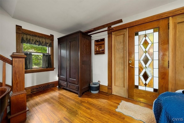 bedroom featuring wood-type flooring and baseboards