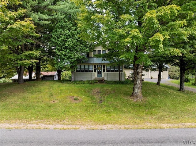 obstructed view of property featuring a front yard