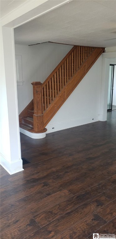 interior space featuring baseboards and wood finished floors