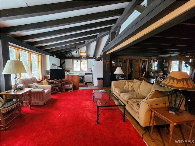 interior space featuring vaulted ceiling with beams and carpet