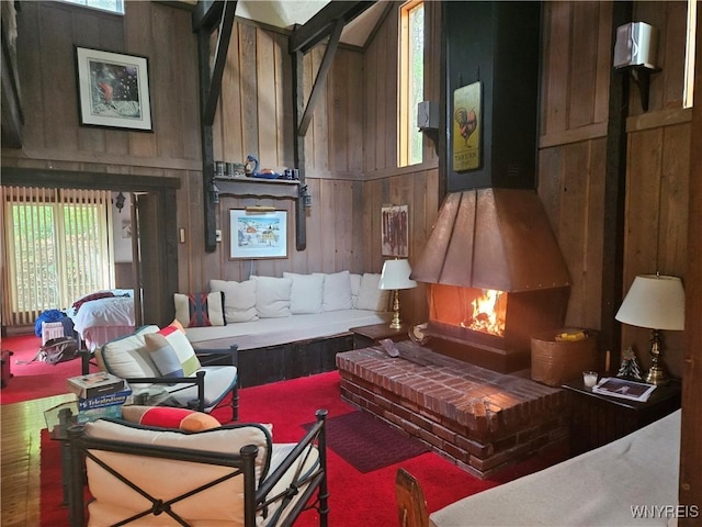 living area with wood walls and a high ceiling