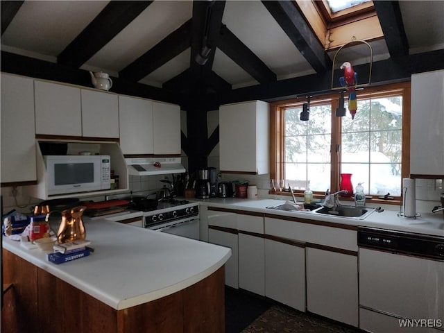 kitchen featuring light countertops, decorative backsplash, range hood, white appliances, and a sink