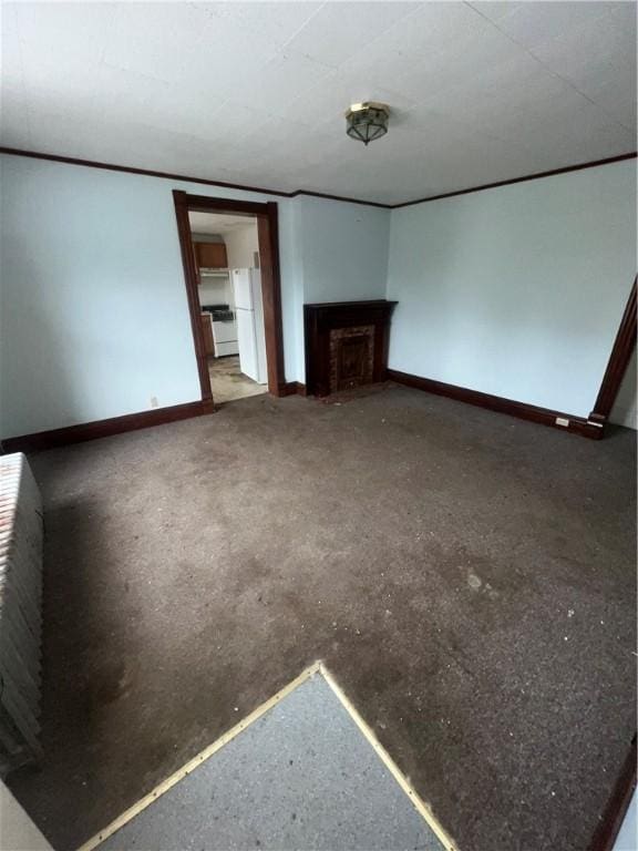 unfurnished living room featuring a fireplace and baseboards