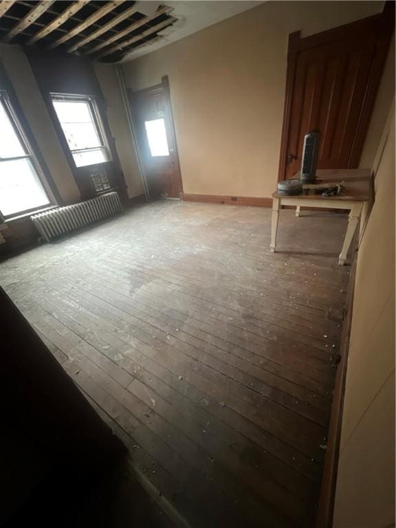 unfurnished room with light wood-type flooring and radiator