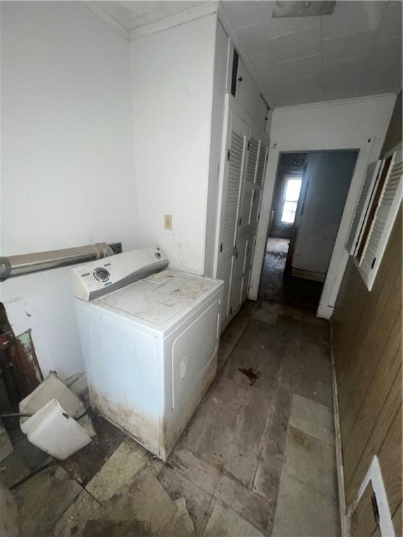 bathroom featuring ornamental molding and washer / clothes dryer