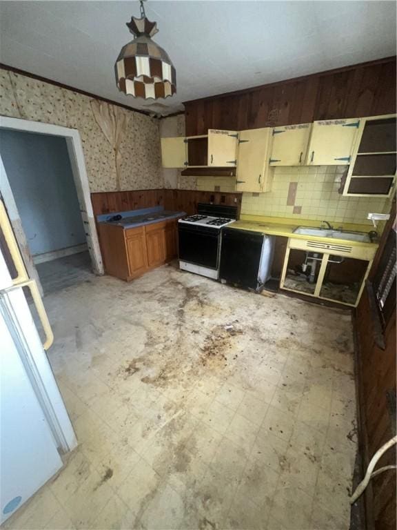 kitchen featuring a sink, light floors, white gas range, and open shelves