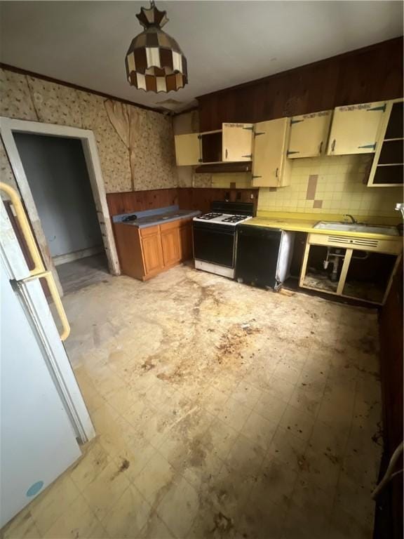 kitchen featuring open shelves, white appliances, a sink, light floors, and tasteful backsplash