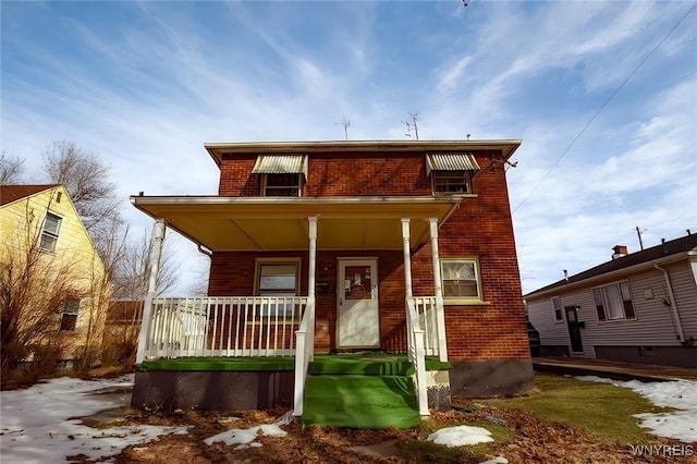 view of front of house with covered porch and brick siding