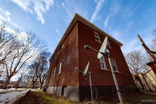 view of side of home featuring brick siding