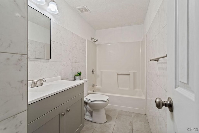 full bath featuring tile patterned flooring, toilet, visible vents, vanity, and tile walls