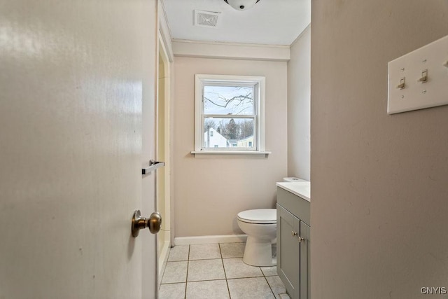 bathroom with visible vents, toilet, vanity, tile patterned flooring, and baseboards