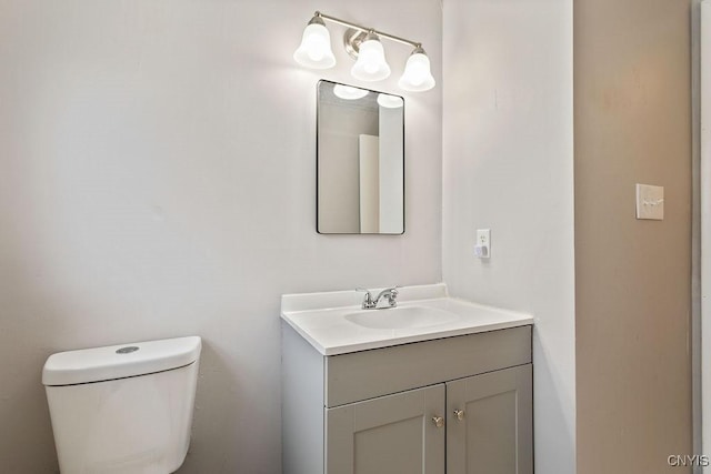 half bathroom featuring toilet and vanity