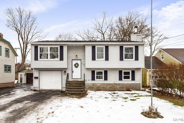 split foyer home with a garage and a chimney