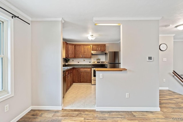 kitchen featuring brown cabinetry, decorative backsplash, appliances with stainless steel finishes, ornamental molding, and under cabinet range hood