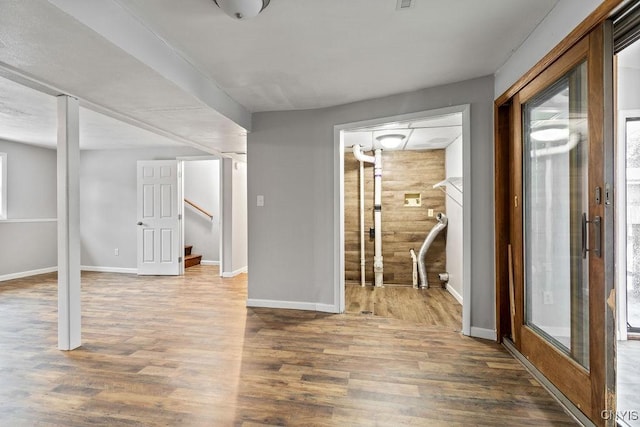 interior space featuring stairs, baseboards, and wood finished floors