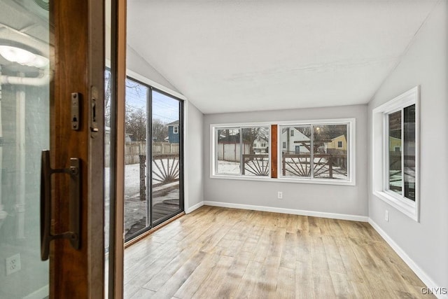 unfurnished sunroom with lofted ceiling