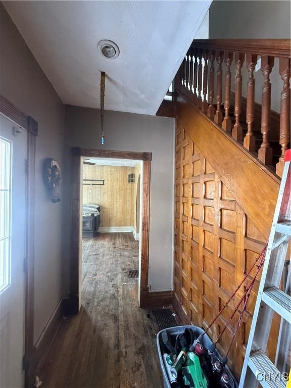 hall featuring wood finished floors and baseboards