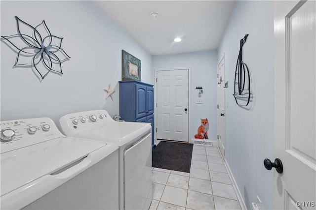 laundry room featuring light tile patterned floors, laundry area, washing machine and dryer, and baseboards