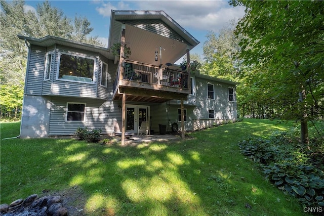 back of property featuring a yard, french doors, and a wooden deck