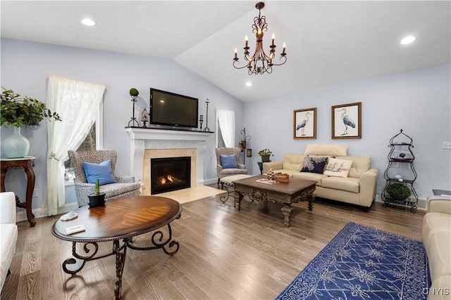 living room with lofted ceiling, a fireplace, wood finished floors, and recessed lighting