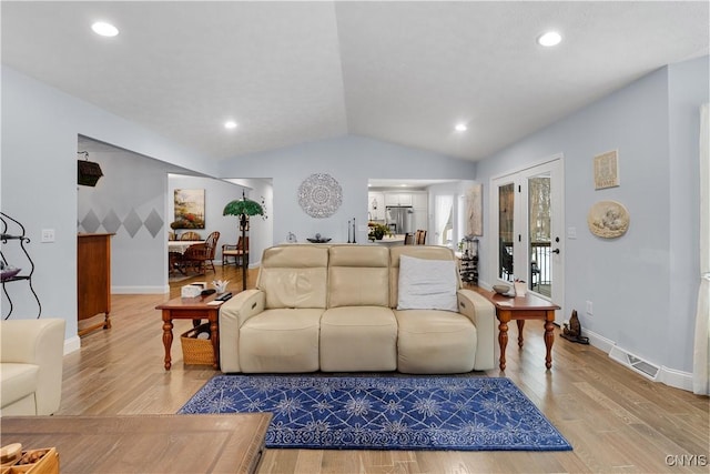 living area with vaulted ceiling, recessed lighting, baseboards, and light wood-style floors