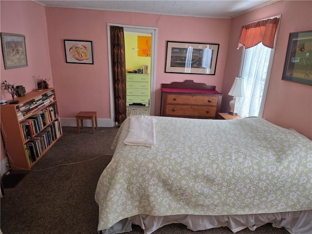 bedroom with baseboards, carpet, connected bathroom, and crown molding