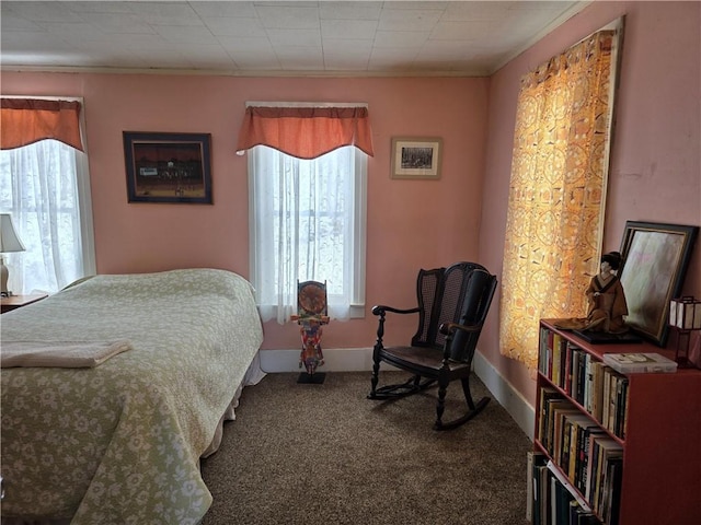 bedroom featuring baseboards and carpet flooring