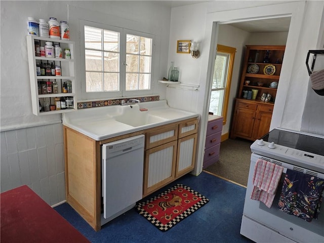 kitchen featuring dark colored carpet, white appliances, light countertops, and wainscoting