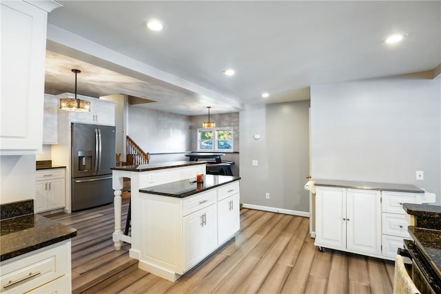 kitchen featuring recessed lighting, white cabinetry, stainless steel refrigerator with ice dispenser, and light wood finished floors